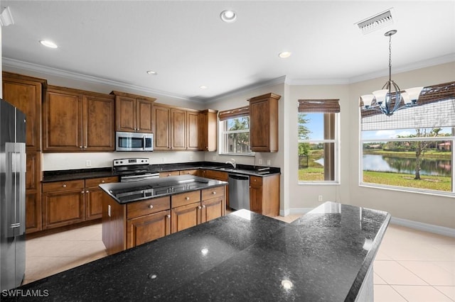 10310 Carolina Willow Dr, Fort Myers, FL 33913 - kitchen featuring appliances with stainless steel finishes, a kitchen island, light tile patterned floors, a chandelier, and ornamental molding