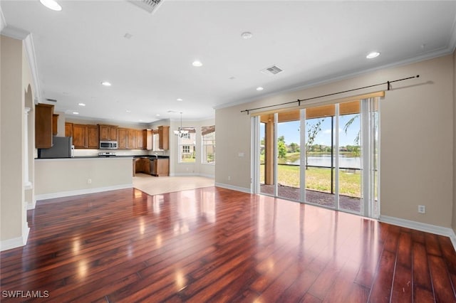 10310 Carolina Willow Dr, Fort Myers, FL 33913 - unfurnished living room with ornamental molding, wood finished floors, recessed lighting, baseboards, and a water view