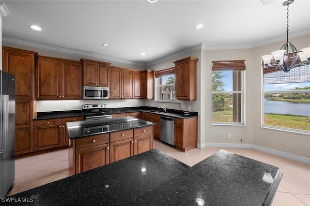 10310 Carolina Willow Dr, Fort Myers, FL 33913 - kitchen with stainless steel appliances, light tile patterned floors, a chandelier, a kitchen island, and crown molding