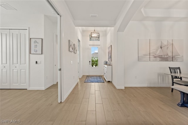 14860 Cherry Blossom Way, Punta Gorda, FL 33955 - entryway with light wood-type flooring, a chandelier, baseboards, and arched walkways
