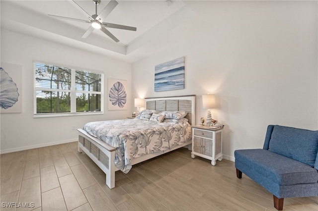 14860 Cherry Blossom Way, Punta Gorda, FL 33955 - bedroom with light wood-style flooring, baseboards, and a tray ceiling