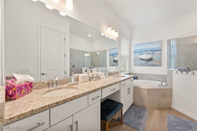 14860 Cherry Blossom Way, Punta Gorda, FL 33955 - full bath featuring tiled shower, wood finished floors, a bath, and double vanity