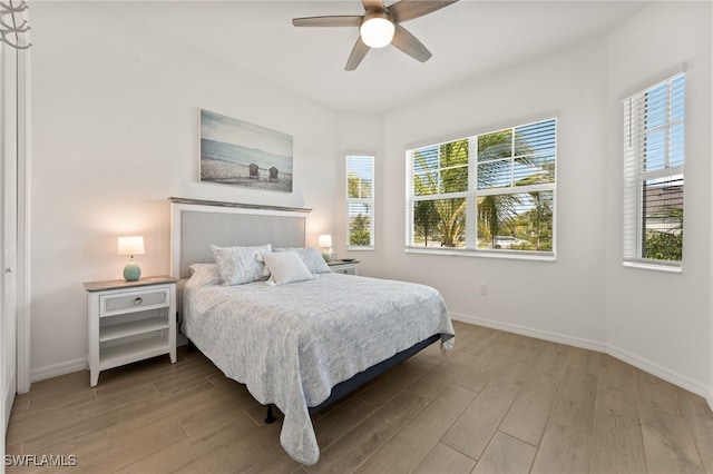 14860 Cherry Blossom Way, Punta Gorda, FL 33955 - bedroom with light wood-type flooring, baseboards, and a ceiling fan