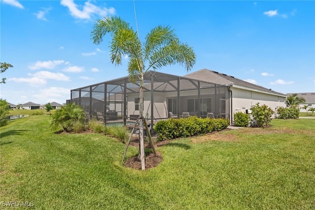14860 Cherry Blossom Way, Punta Gorda, FL 33955 - rear view of house featuring a lawn, a lanai, and an outdoor pool