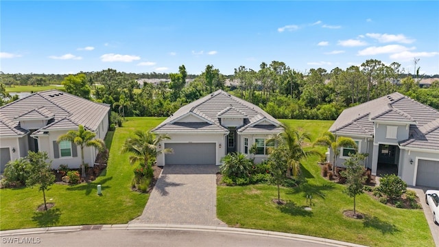 14860 Cherry Blossom Way, Punta Gorda, FL 33955 - view of front of home with an attached garage, driveway, a tiled roof, and a front lawn