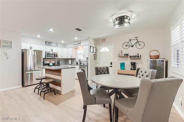 114 Lovers Ln, Fort Myers Beach, FL 33931 - dining room featuring healthy amount of natural light, recessed lighting, baseboards, and light wood finished floors