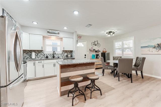 114 Lovers Ln, Fort Myers Beach, FL 33931 - kitchen featuring stainless steel appliances, a sink, decorative backsplash, healthy amount of natural light, and recessed lighting