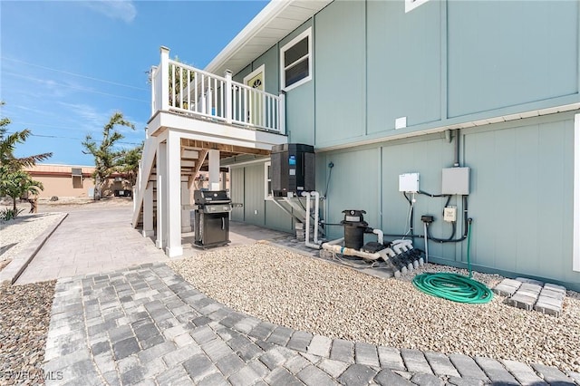 114 Lovers Ln, Fort Myers Beach, FL 33931 - rear view of house featuring a balcony and a patio area