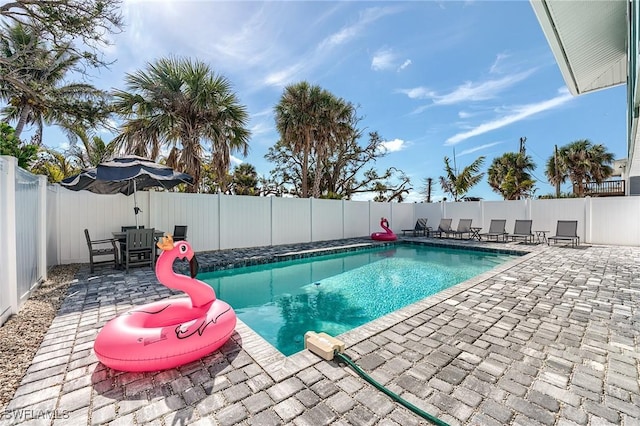 114 Lovers Ln, Fort Myers Beach, FL 33931 - view of swimming pool featuring a fenced backyard and a patio area