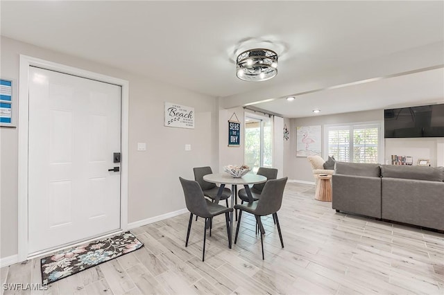 114 Lovers Ln, Fort Myers Beach, FL 33931 - dining area featuring baseboards and light wood-type flooring