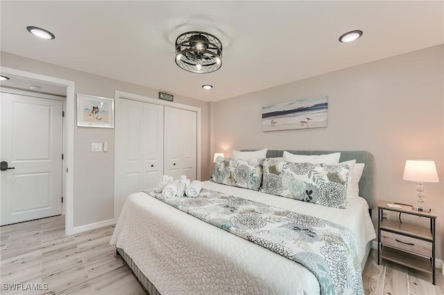 114 Lovers Ln, Fort Myers Beach, FL 33931 - bedroom with baseboards, light wood-style floors, a closet, and recessed lighting