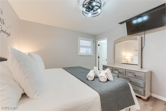 114 Lovers Ln, Fort Myers Beach, FL 33931 - bedroom with light wood-type flooring and baseboards