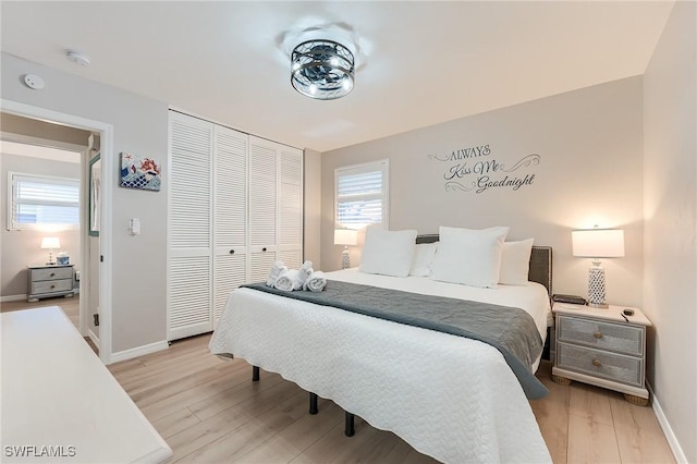 114 Lovers Ln, Fort Myers Beach, FL 33931 - bedroom featuring light wood finished floors, baseboards, and a closet