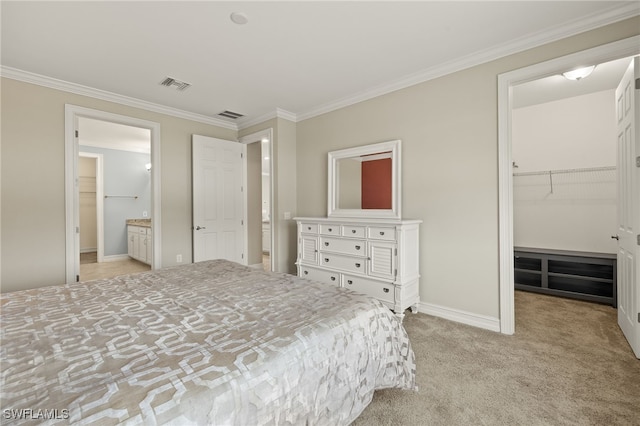 bedroom with light colored carpet, a spacious closet, crown molding, baseboards, and a closet