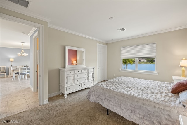 bedroom with a chandelier, crown molding, carpet, baseboards, and tile patterned floors