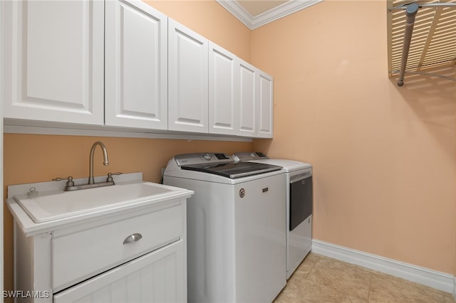 laundry room with washing machine and clothes dryer, cabinet space, crown molding, baseboards, and light tile patterned floors