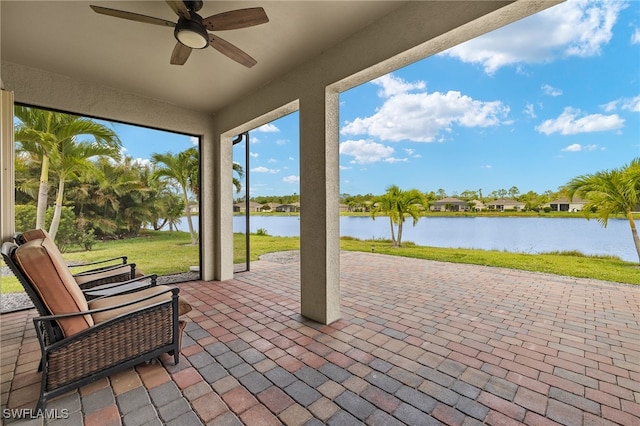 view of patio / terrace with a water view and a ceiling fan