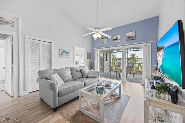 living room featuring high vaulted ceiling, wood finished floors, and a ceiling fan