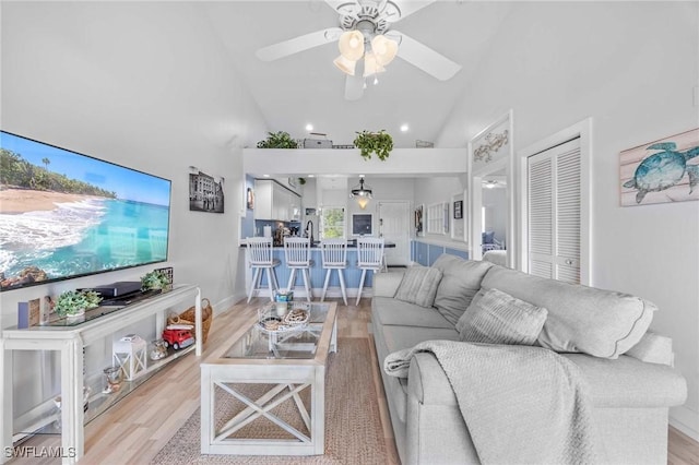 living area featuring ceiling fan, wood finished floors, high vaulted ceiling, and recessed lighting