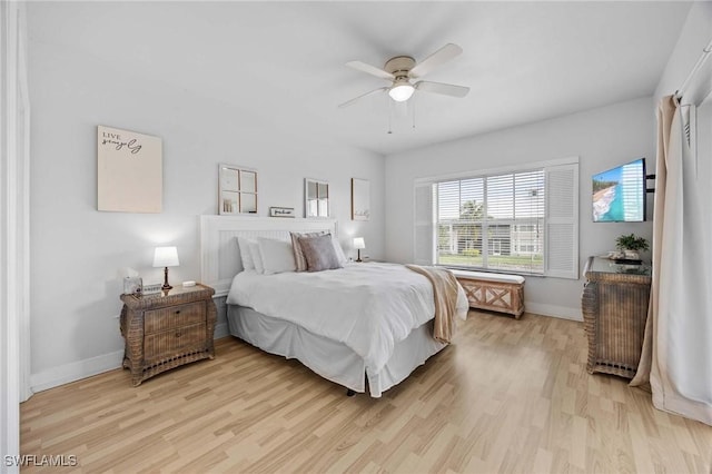 bedroom with light wood-style flooring, baseboards, and ceiling fan
