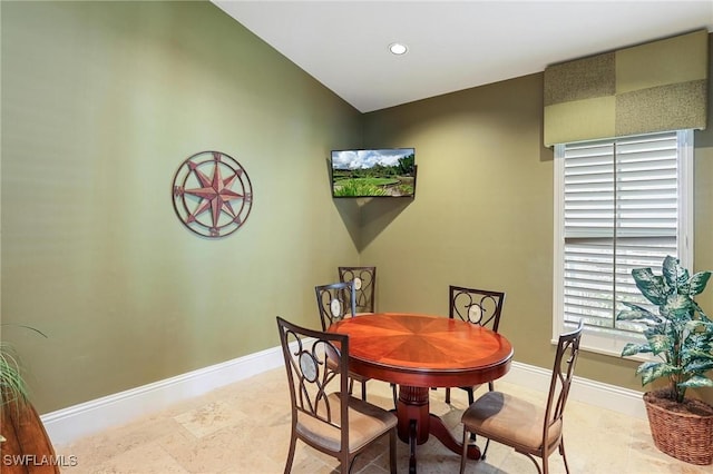 dining room featuring baseboards, recessed lighting, and vaulted ceiling