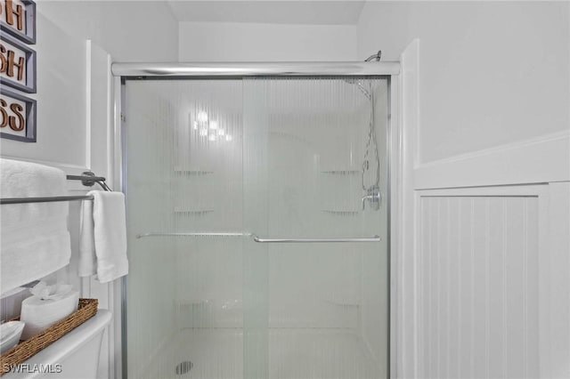 bathroom with a stall shower and toilet