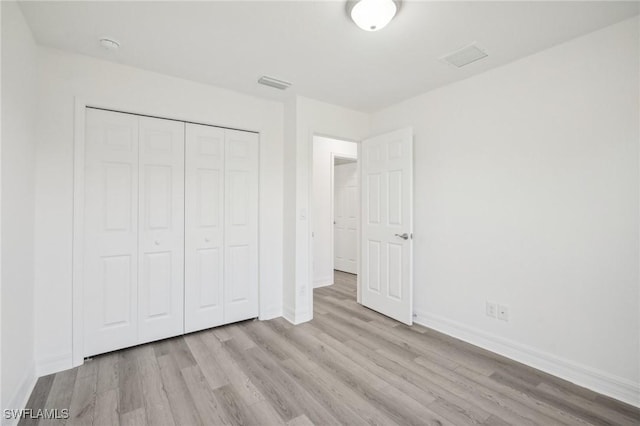 2909 SE 8th Pl, Cape Coral, FL 33904 - unfurnished bedroom featuring wood finished floors, baseboards, and a closet