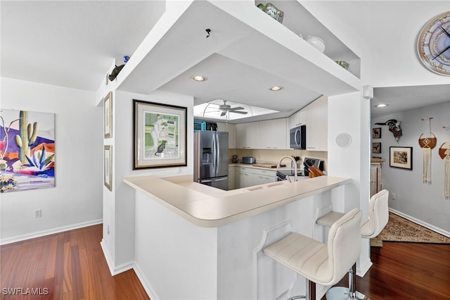 kitchen featuring stainless steel appliances, light countertops, baseboards, ceiling fan, and recessed lighting