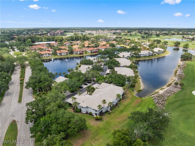aerial perspective of suburban area with a nearby body of water and a golf club