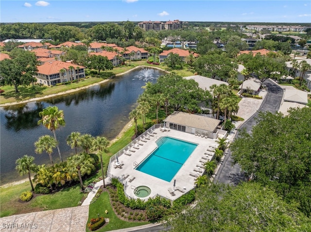 aerial view of a pool area and a nearby body of water