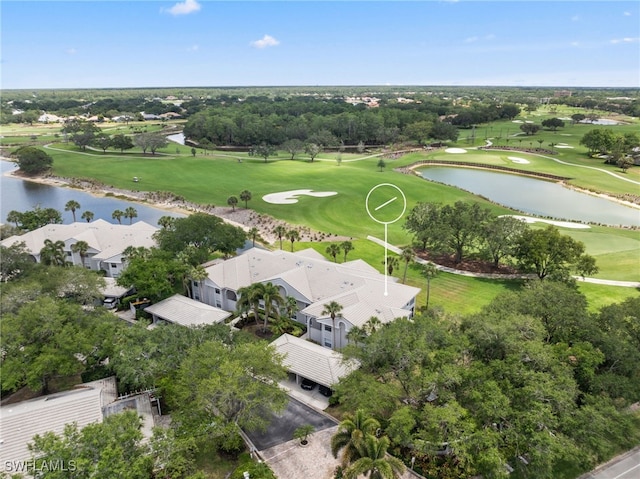 bird's eye view of a large body of water, a local golf course, and a tree filled landscape