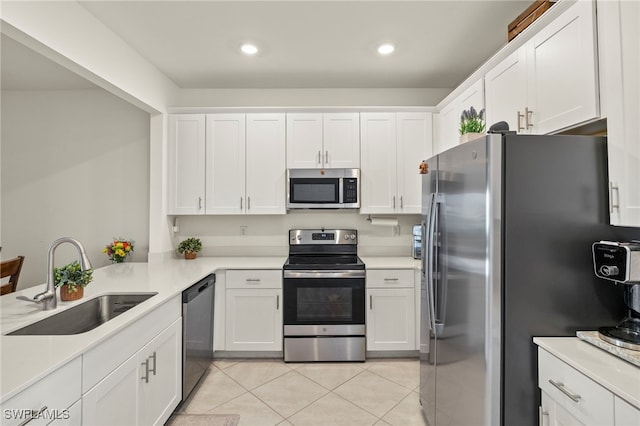 2780 Blossom Way, Naples, FL 34120 - kitchen featuring stainless steel appliances, a sink, light tile patterned flooring, white cabinets, and light countertops