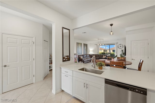 2780 Blossom Way, Naples, FL 34120 - kitchen featuring stainless steel dishwasher, a sink, open floor plan, light countertops, and white cabinetry