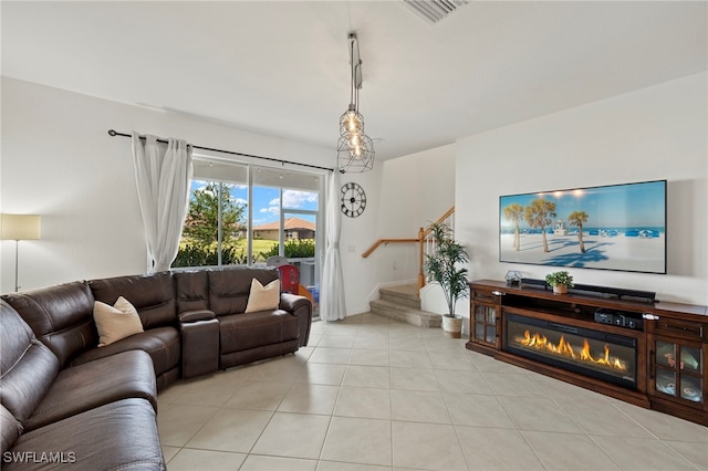 2780 Blossom Way, Naples, FL 34120 - living room with stairs, light tile patterned floors, and a glass covered fireplace