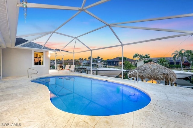 1428 SW 52nd Ln, Cape Coral, FL 33914 - swimming pool featuring a patio area, a boat dock, glass enclosure, and boat lift