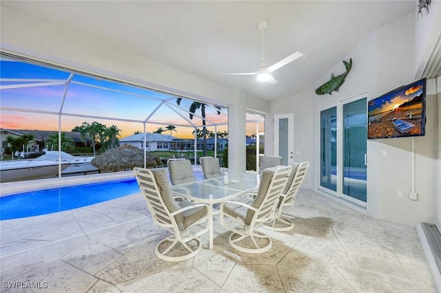 1428 SW 52nd Ln, Cape Coral, FL 33914 - sunroom / solarium featuring a ceiling fan, outdoor dining area, a baseboard heating unit, and lofted ceiling