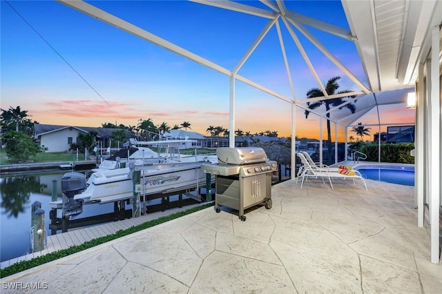 1428 SW 52nd Ln, Cape Coral, FL 33914 - view of patio with boat lift, a dock, area for grilling, and a lanai
