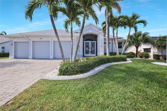 1428 SW 52nd Ln, Cape Coral, FL 33914 - ranch-style house featuring stucco siding, decorative driveway, a front lawn, and a garage