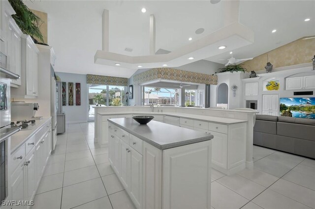 1428 SW 52nd Ln, Cape Coral, FL 33914 - kitchen with a center island, open floor plan, light countertops, recessed lighting, and light tile patterned floors