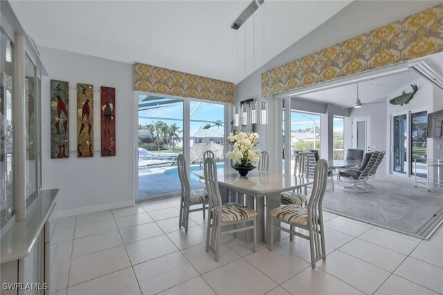 1428 SW 52nd Ln, Cape Coral, FL 33914 - sunroom with vaulted ceiling, baseboards, and tile patterned flooring
