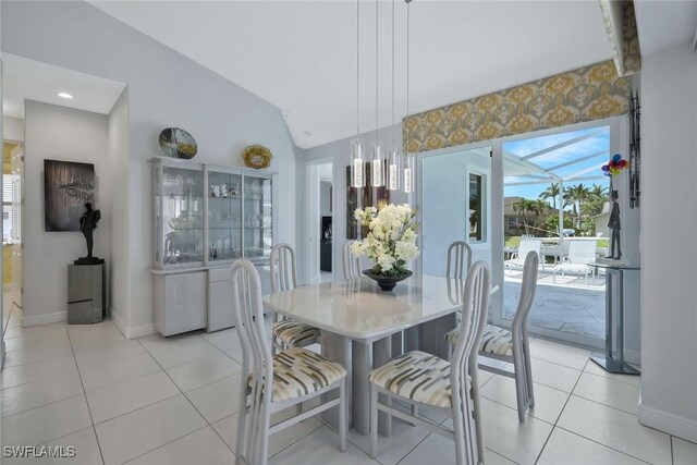 1428 SW 52nd Ln, Cape Coral, FL 33914 - dining area with baseboards, light tile patterned flooring, and lofted ceiling
