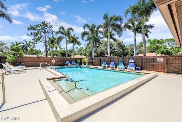 community pool featuring a patio area and fence