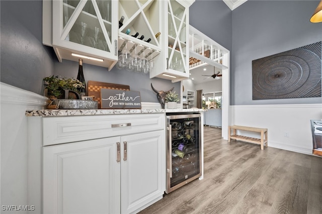 11730 Rosemount Dr, Fort Myers, FL 33913 - indoor dry bar with wine cooler, light wood-style floors, and ceiling fan