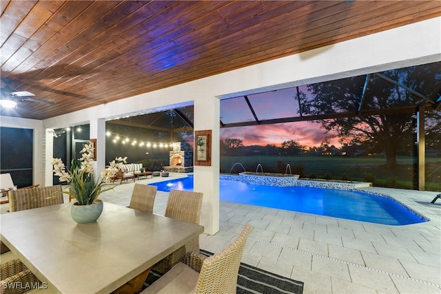 11730 Rosemount Dr, Fort Myers, FL 33913 - pool at dusk with a pool with connected hot tub and a ceiling fan