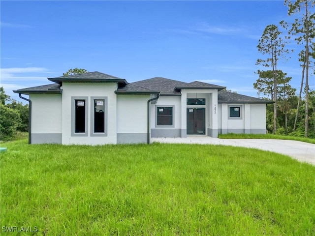 1432 Euclid Ave, Lehigh Acres, FL 33972 - prairie-style house featuring stucco siding and a front lawn
