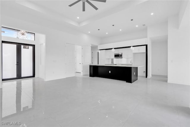 1432 Euclid Ave, Lehigh Acres, FL 33972 - unfurnished living room featuring a ceiling fan, a high ceiling, recessed lighting, french doors, and light tile patterned flooring