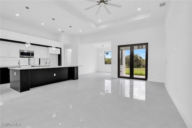 1432 Euclid Ave, Lehigh Acres, FL 33972 - unfurnished living room with ceiling fan, a towering ceiling, recessed lighting, and a tray ceiling