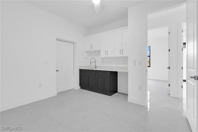 1432 Euclid Ave, Lehigh Acres, FL 33972 - kitchen featuring light countertops, white cabinets, and a ceiling fan