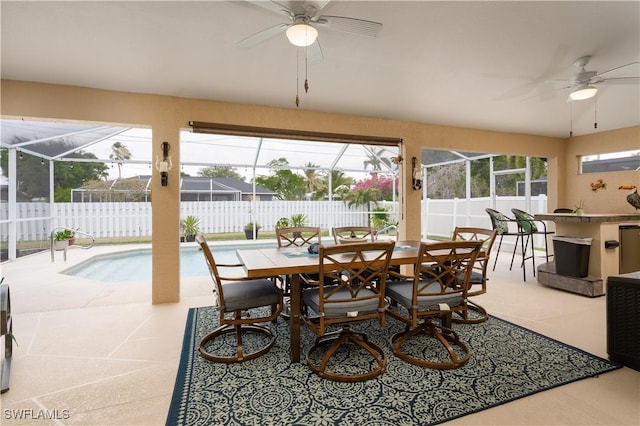 dining space featuring a ceiling fan and a sunroom