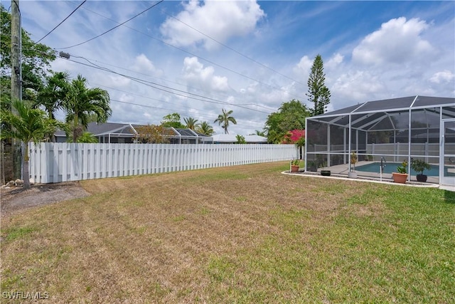 view of yard featuring glass enclosure